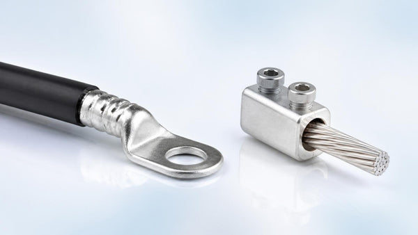Copper compression lug beside an aluminum mechanical set-screw lug | Conversions Tech